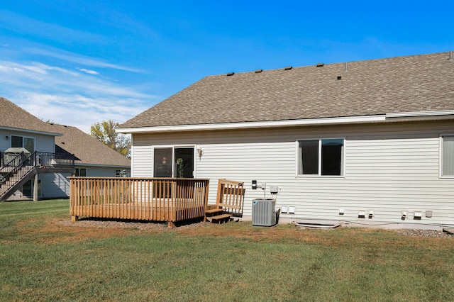 rear view of house featuring a shingled roof, a lawn, cooling unit, and a wooden deck