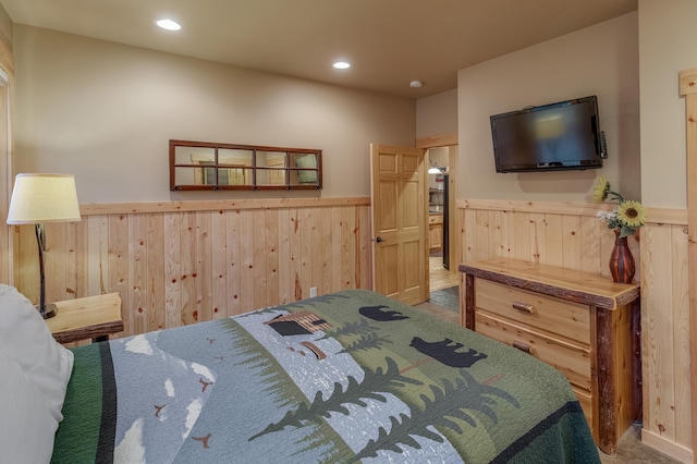 bedroom featuring wooden walls