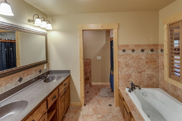 bathroom with vanity, tiled bath, and tile patterned flooring