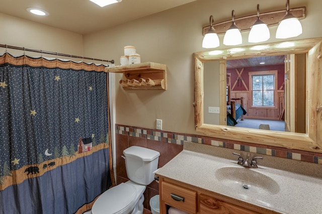 bathroom with walk in shower, vanity, and toilet