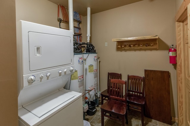 washroom with tile patterned flooring and stacked washer and dryer