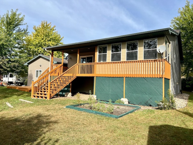 rear view of house featuring a yard and a deck