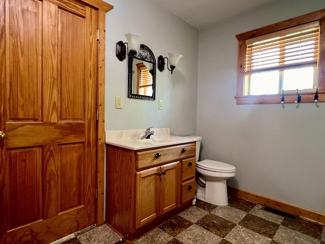 bathroom with vanity and toilet