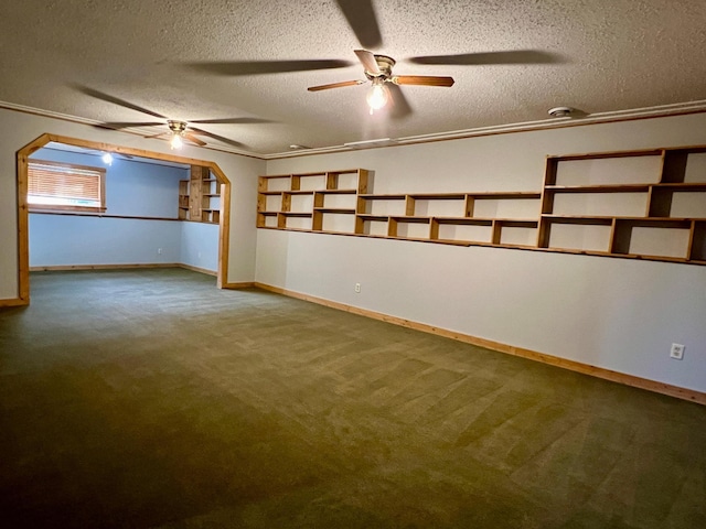 empty room featuring a textured ceiling, carpet flooring, and crown molding