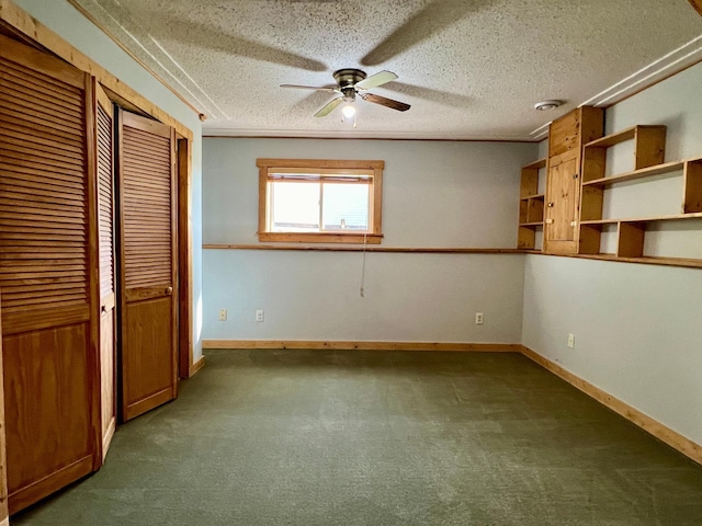 unfurnished bedroom with dark carpet, a textured ceiling, and ceiling fan