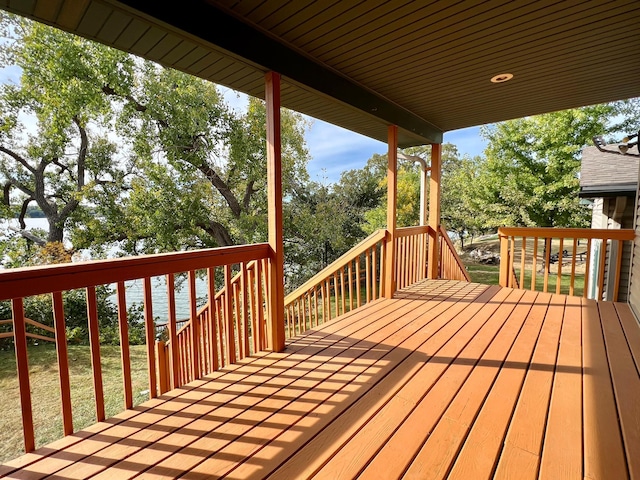 deck featuring a yard and a water view