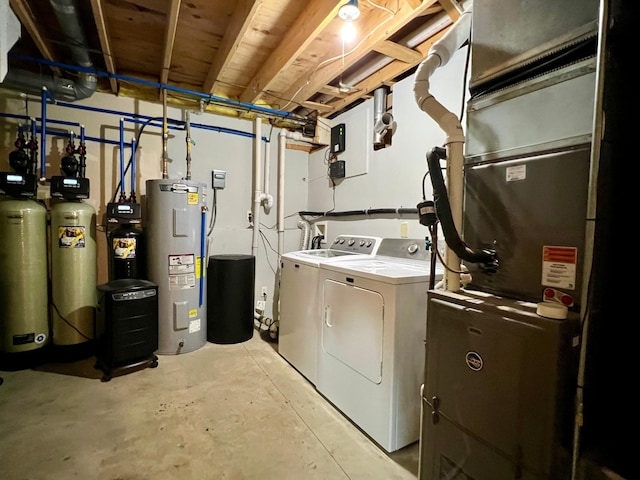 laundry area with washing machine and clothes dryer, heating unit, and water heater