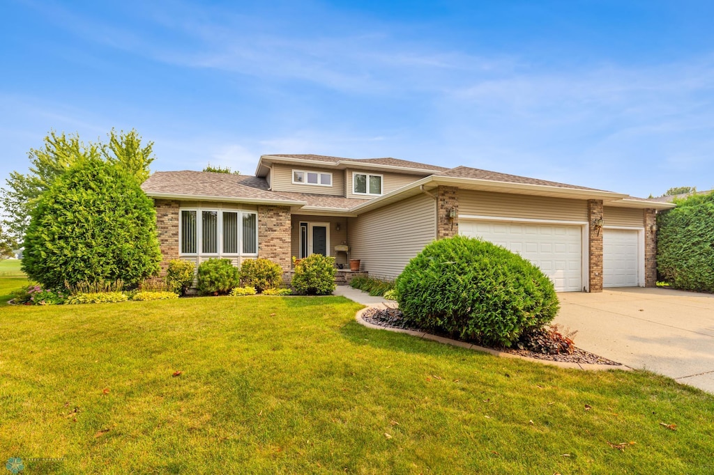 view of front of property featuring a garage and a front lawn