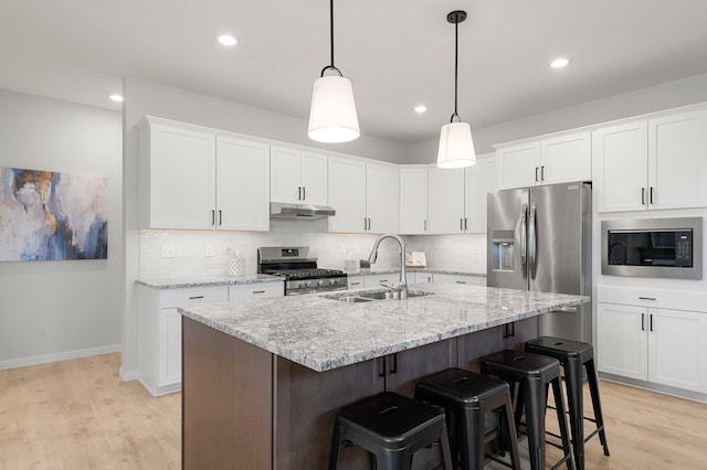 kitchen featuring appliances with stainless steel finishes, sink, and white cabinetry