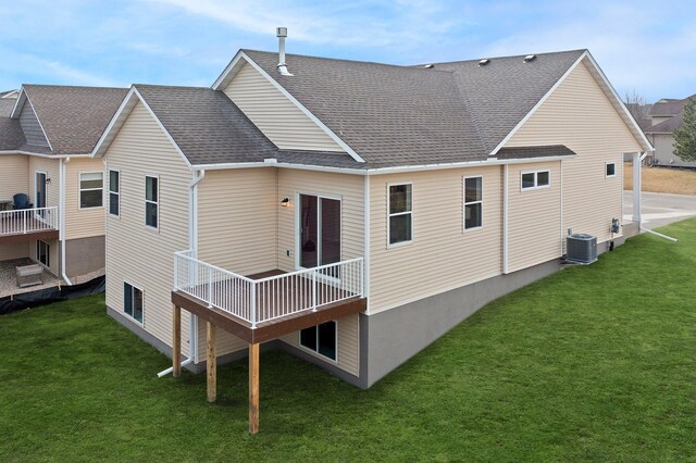 back of property with a yard, central AC, and a wooden deck