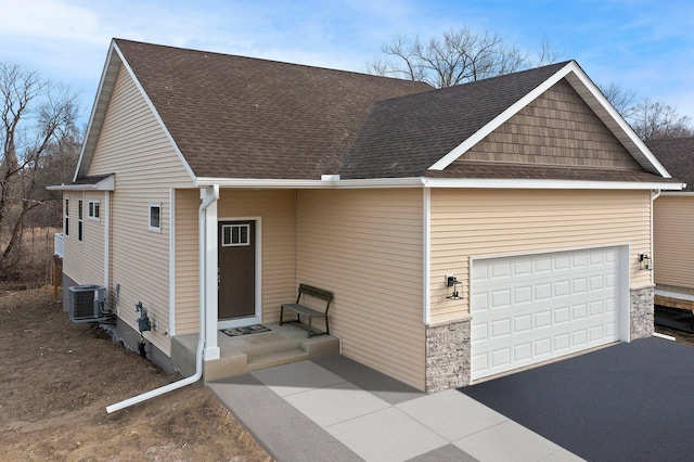 exterior space featuring a garage and central AC