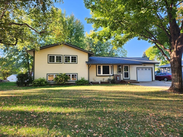 split level home with a front yard and a garage