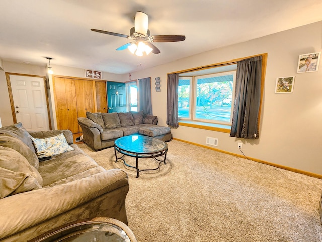 carpeted living room with ceiling fan