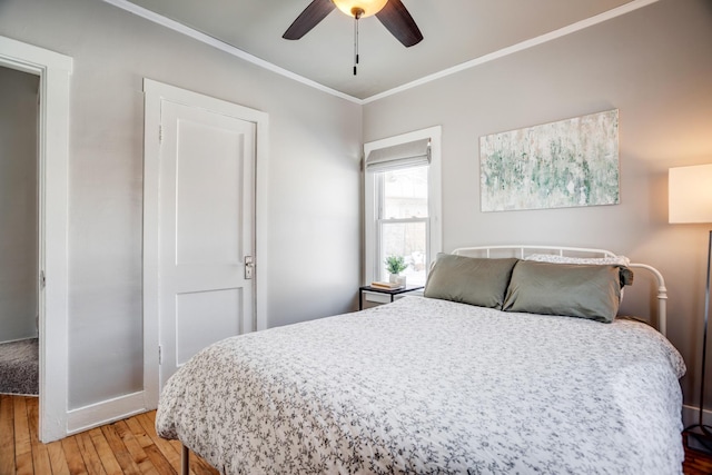 bedroom with ceiling fan, ornamental molding, light wood-type flooring, and baseboards