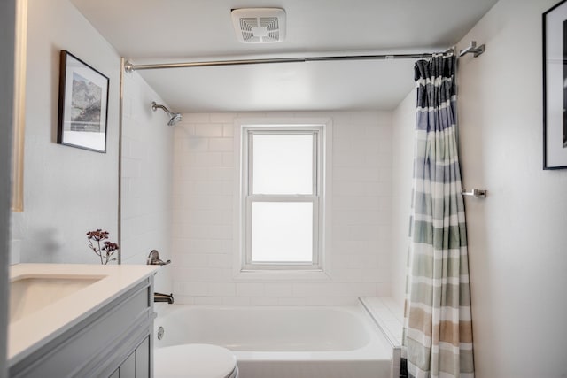 bathroom featuring toilet, vanity, visible vents, and shower / bathtub combination with curtain