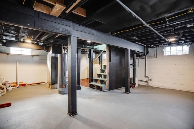 basement with washer / clothes dryer, water heater, and stairs