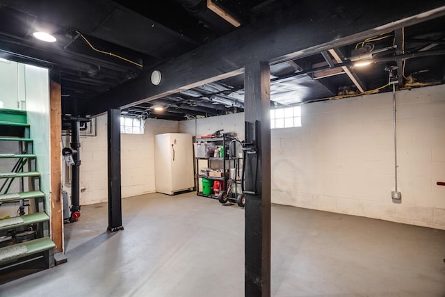 basement featuring freestanding refrigerator