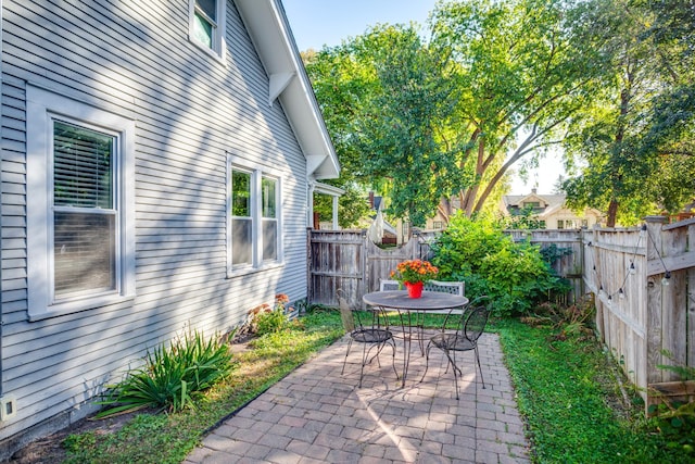 view of patio featuring outdoor dining space and a fenced backyard