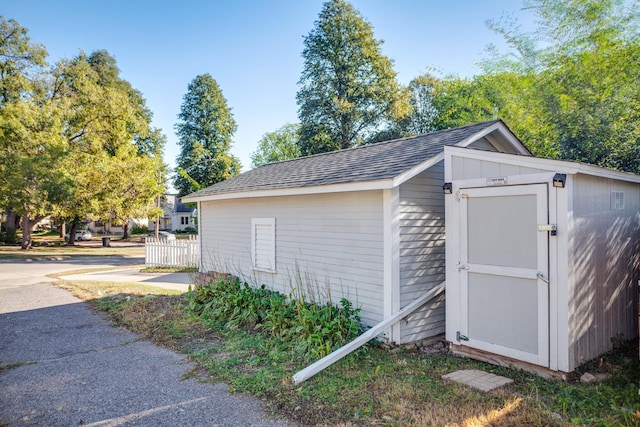 view of shed featuring fence