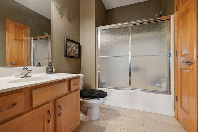 full bathroom with toilet, vanity, bath / shower combo with glass door, and tile patterned flooring