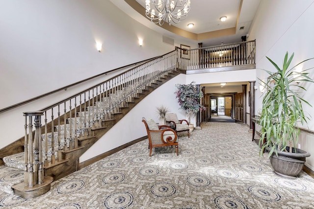 stairs with a high ceiling and a chandelier