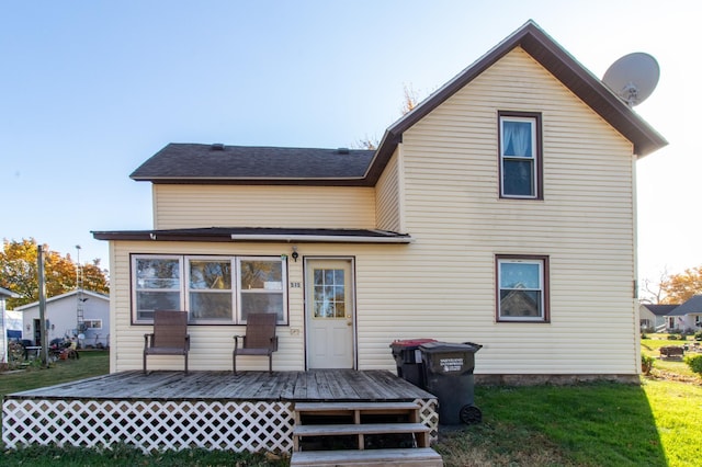 back of property featuring a wooden deck