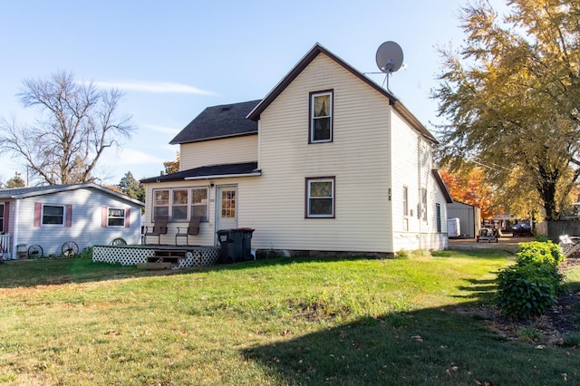 rear view of house featuring a yard