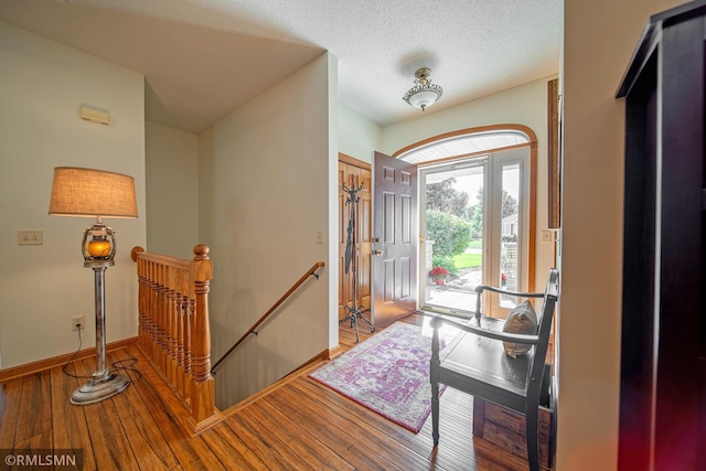 entrance foyer featuring a textured ceiling and light hardwood / wood-style floors