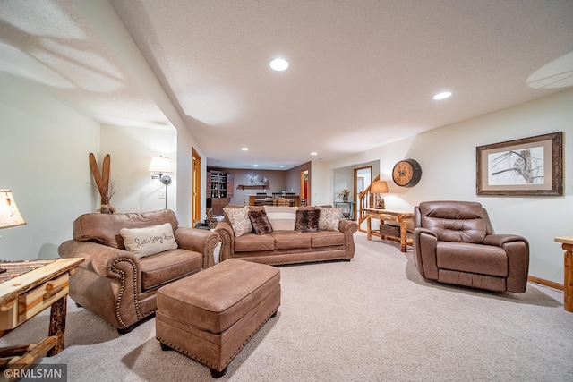 carpeted living room featuring a textured ceiling