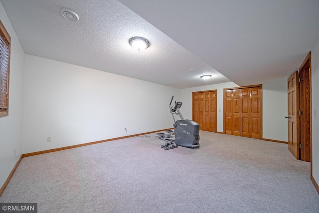 workout room with carpet floors and a textured ceiling