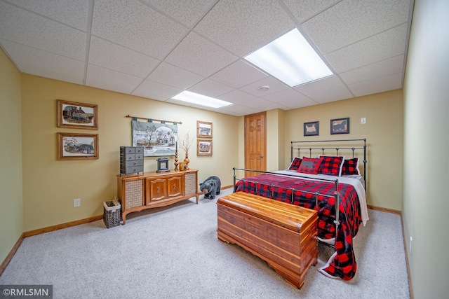 carpeted bedroom with a paneled ceiling