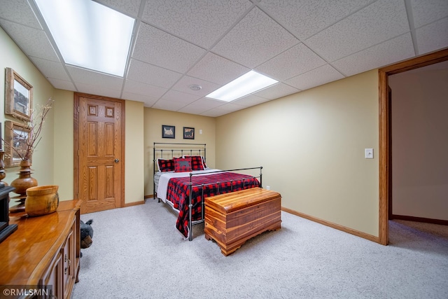 carpeted bedroom featuring a paneled ceiling