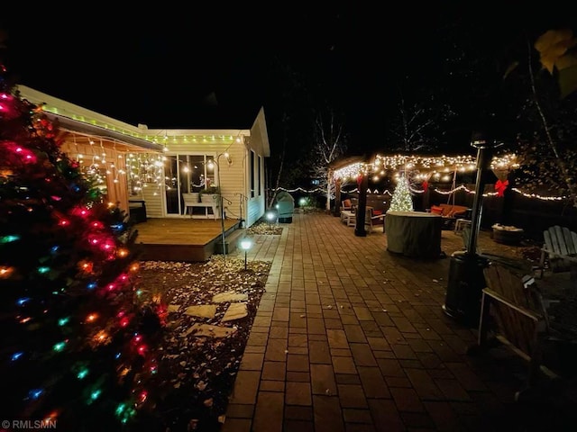 patio at night with a wooden deck