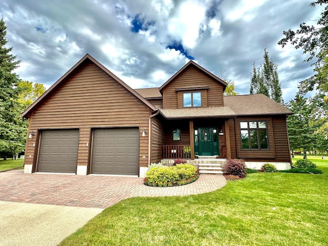 312 Oakdale Ct NE, Warroad, MN 56763 - view of front of property featuring decorative driveway, a front yard, an attached garage, and a shingled roof