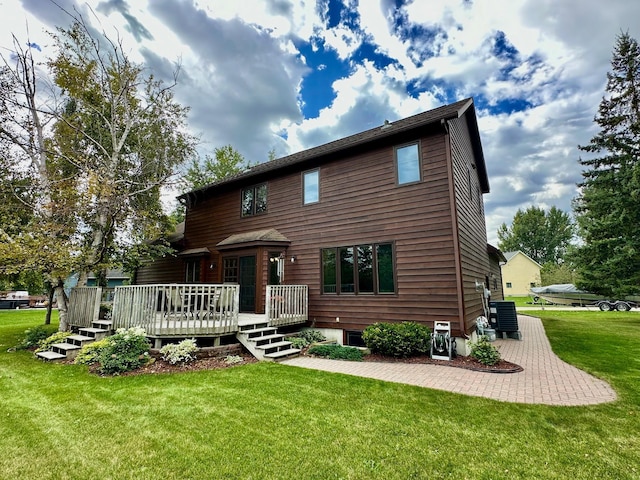 view of front facade with a wooden deck and a front lawn