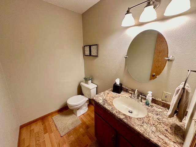 bathroom featuring hardwood / wood-style floors, vanity, and toilet