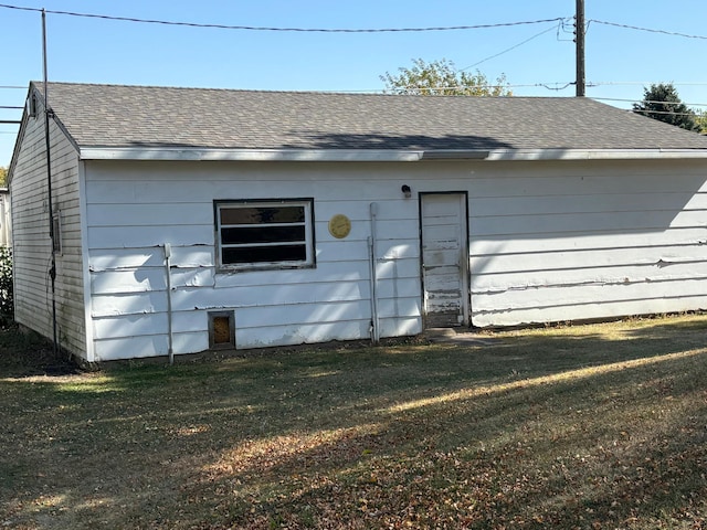 rear view of property with a yard