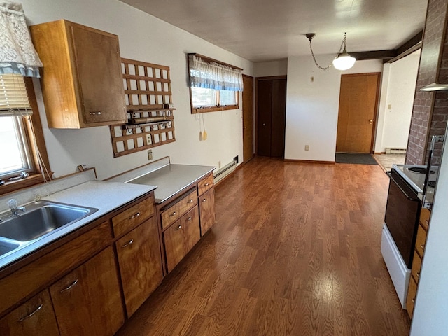 kitchen featuring white range with electric cooktop, plenty of natural light, dark hardwood / wood-style flooring, and pendant lighting