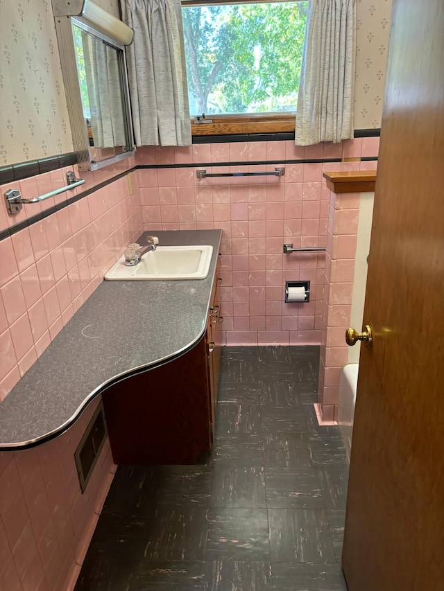 bathroom with tile walls and vanity