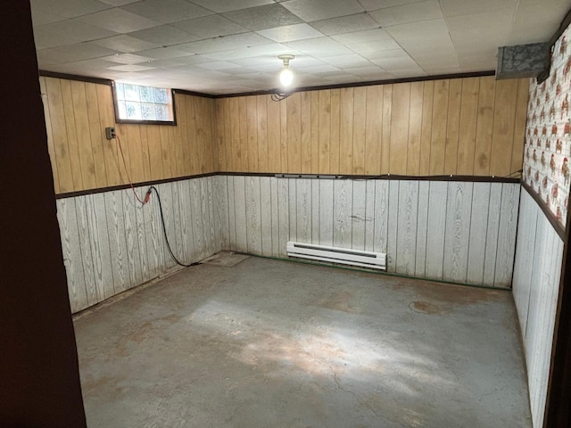 basement with wood walls and baseboard heating