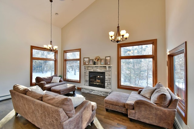 living room with a fireplace, baseboard heating, dark hardwood / wood-style floors, high vaulted ceiling, and a chandelier