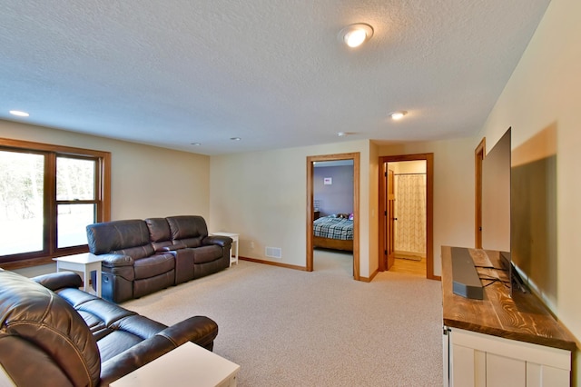 living room with a textured ceiling and light carpet