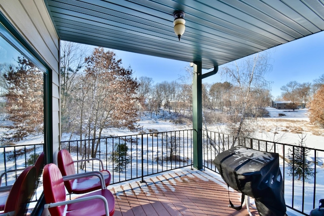 snow covered deck featuring a grill