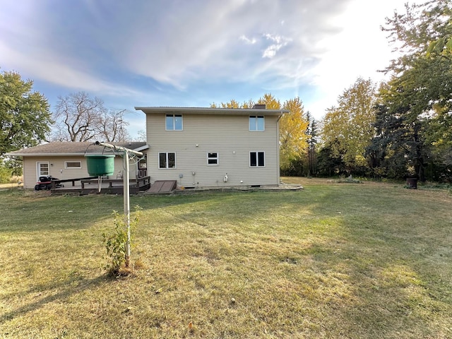 back of house featuring a yard and a deck