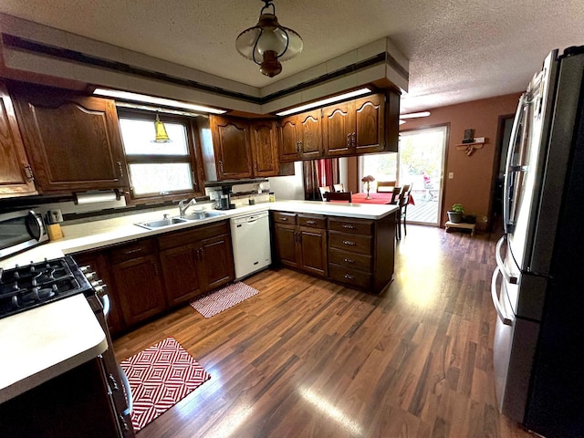 kitchen featuring sink, appliances with stainless steel finishes, plenty of natural light, and kitchen peninsula