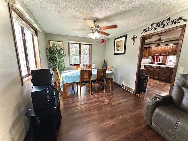 dining room with wood-type flooring, a textured ceiling, and ceiling fan