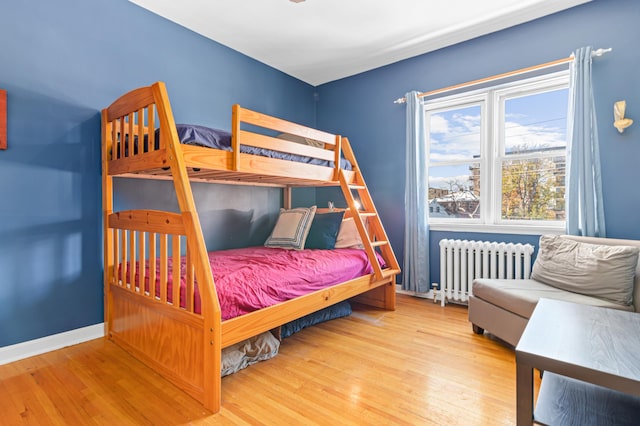 bedroom featuring wood-type flooring and radiator