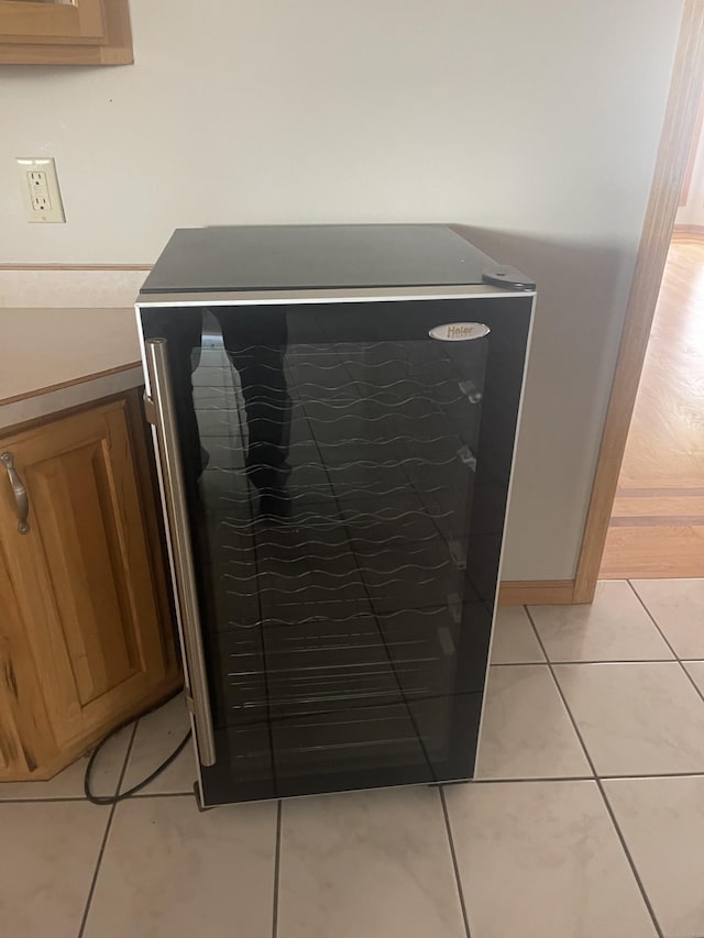 details with wine cooler and tile patterned floors