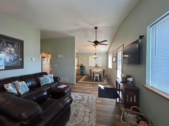 living room with wood-type flooring, vaulted ceiling, and ceiling fan