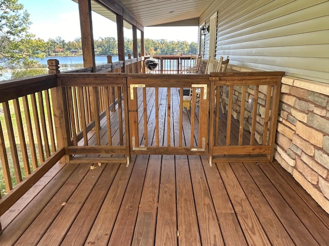 wooden deck featuring a water view